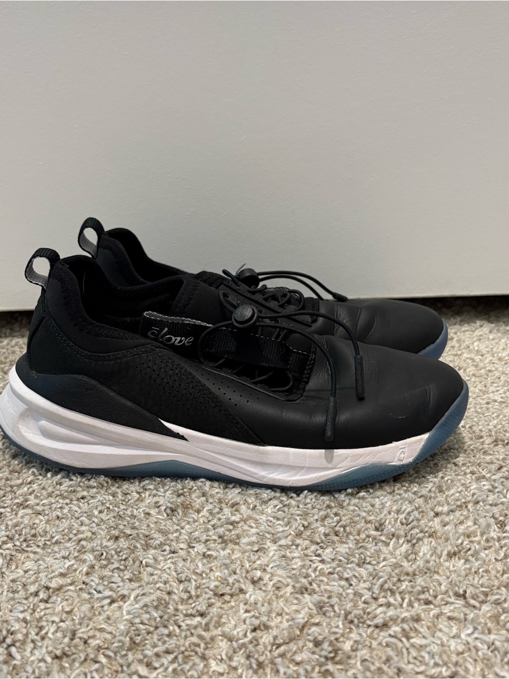 Clove Black Slip-On Sneakers with White Midsole and Blue Outsole